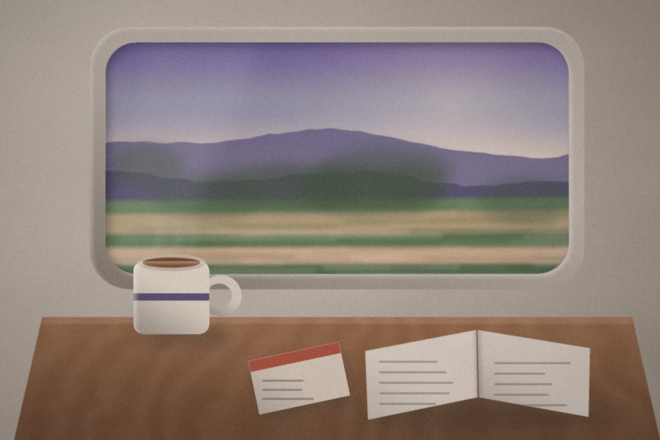 A window looking out over violet hills, with a mug and an open book on the table.